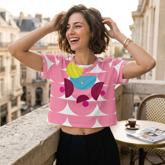 Good Wishes 365 pink crop tee with mushroom pattern worn by a smiling woman on a balcony
