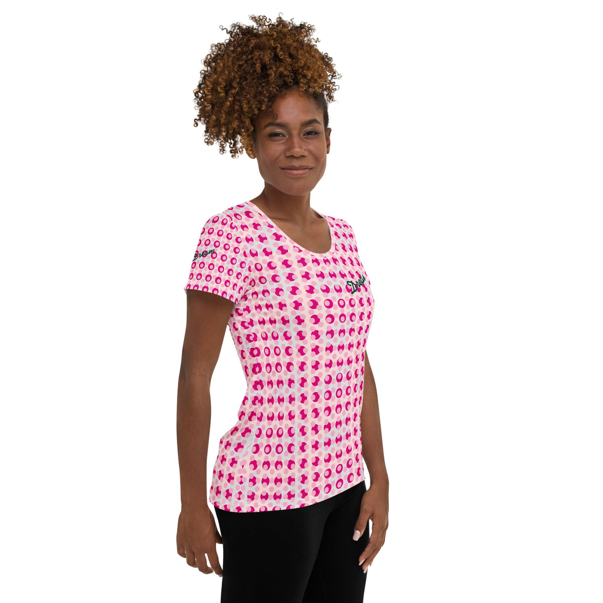 Good Wishes 365 women's athletic t-shirt with a pink polka dot print, featuring Dream text on a model.