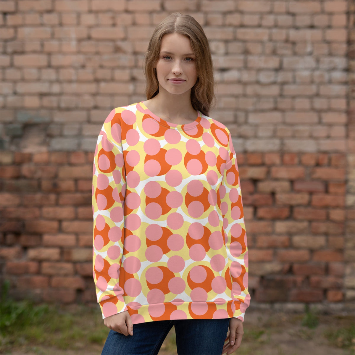 Good Wishes 365 recycled sweatshirt featuring a 70s pop art geometric print in pink, orange, and yellow on a woman.