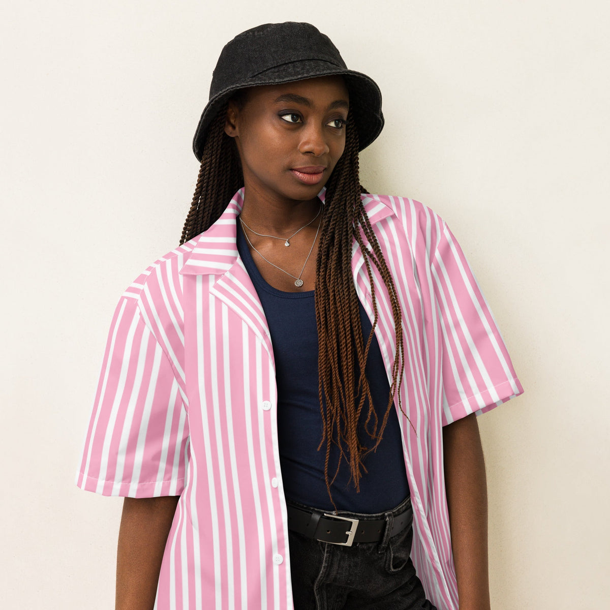 Good Wishes 365 pink and white striped short sleeve button-up shirt worn open over a dark tank top by a model.
