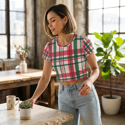 Good Wishes 365 woman wearing a pink and green plaid all-over print crop tee with jeans in a bright loft setting.