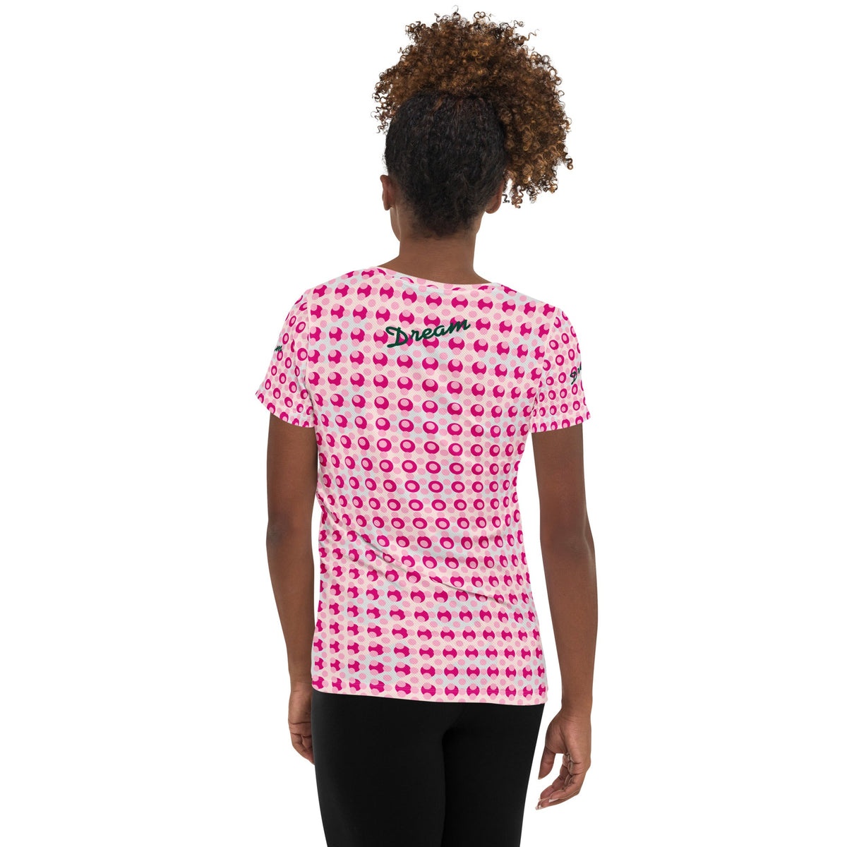 Good Wishes 365 women's athletic t-shirt with a pink polka dot print and Dream text, back view on a model.