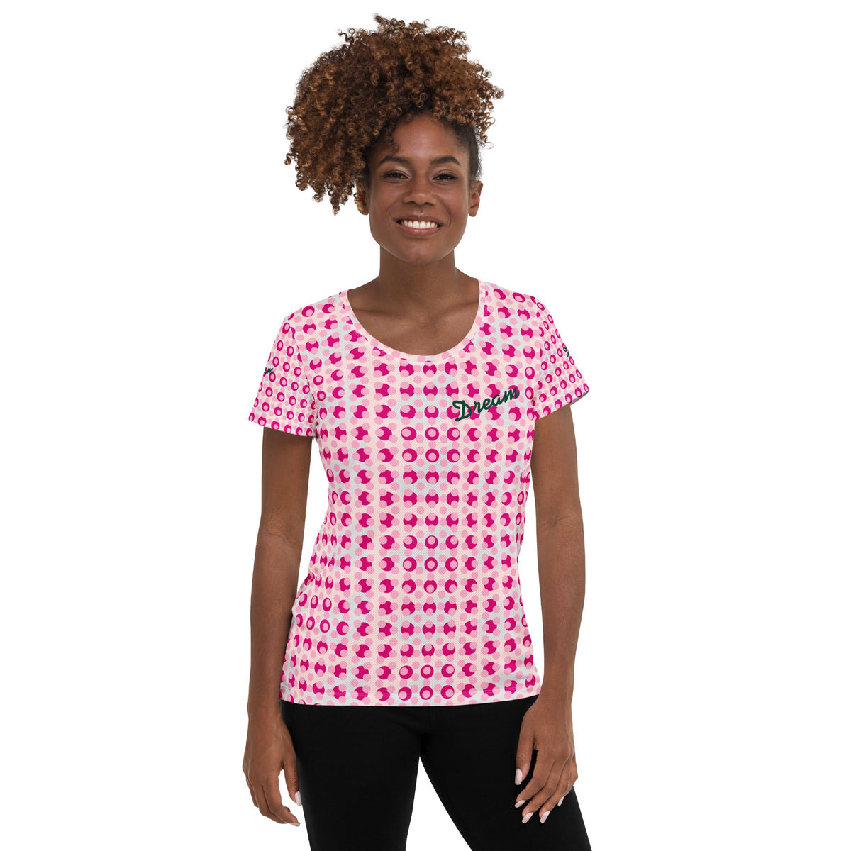 Good Wishes 365 women's athletic t-shirt with a pink polka dot print and Dream text on a smiling model