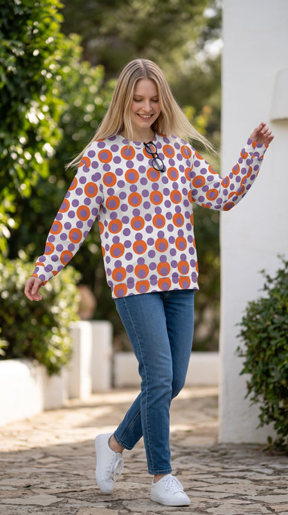 Good Wishes 365 recycled sweatshirt with 70s pop art orange and purple polka dot print on a woman in blue jeans