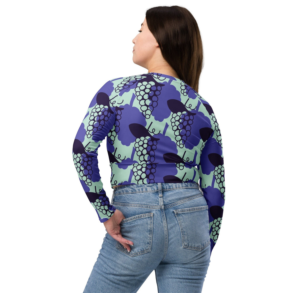 Good Wishes 365 long-sleeve crop top in purple and mint grape print, worn by a woman with blue jeans, back view.