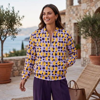 Good Wishes 365 unisex bomber jacket with purple and yellow retro polka dot and semi-circle print, fleece-lined.