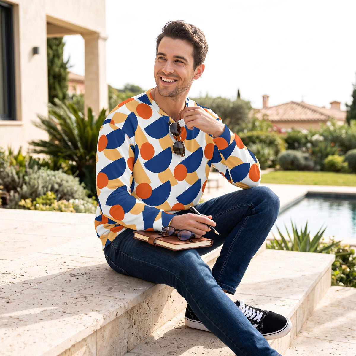 Good Wishes 365 unisex sweatshirt with mushroom print in dark cerulean, orange, and yellow worn by a smiling man