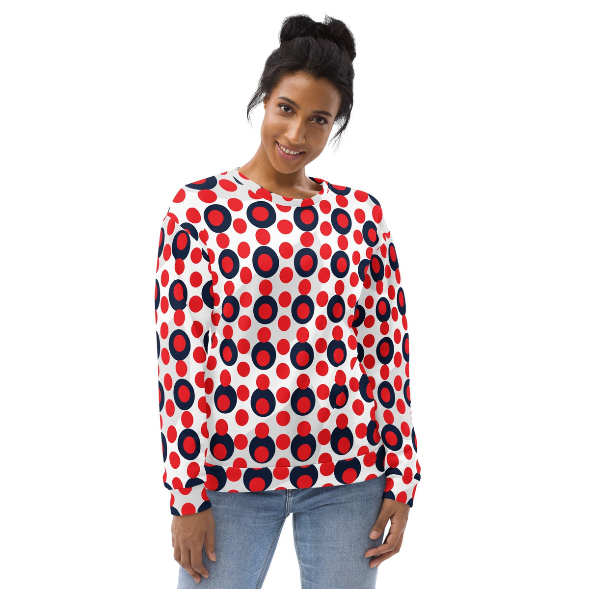 A woman wearing a Good Wishes 365 recycled sweatshirt with a 70s pop art red and navy polka dot print on white.