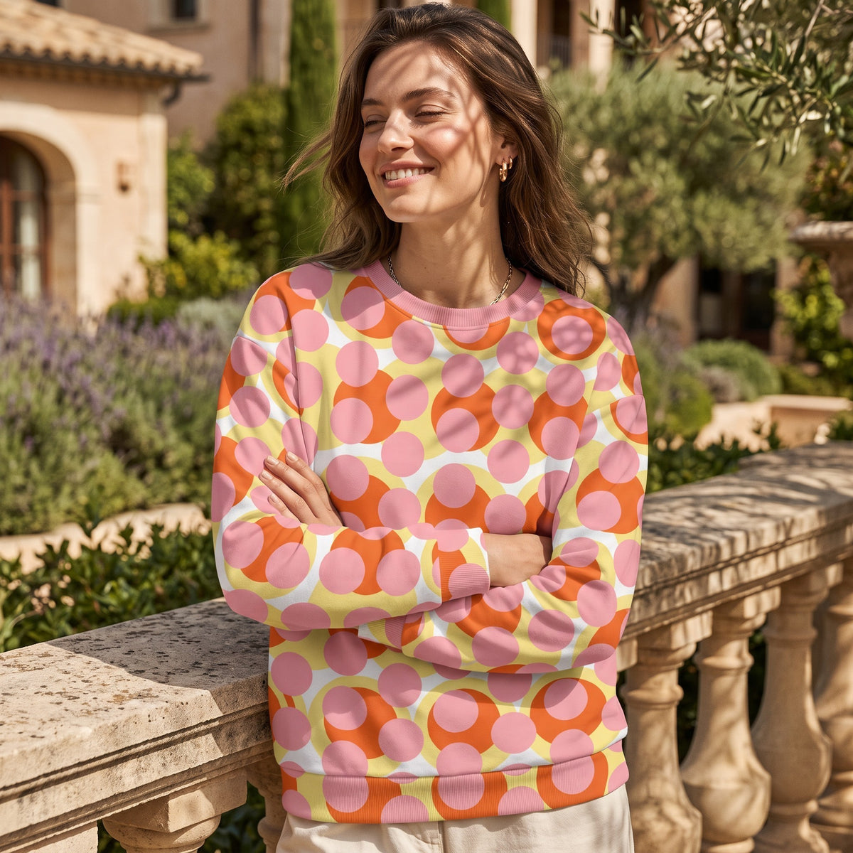 Good Wishes 365 recycled sweatshirt with 70s pop art pink, orange, and yellow geometric print on a smiling woman