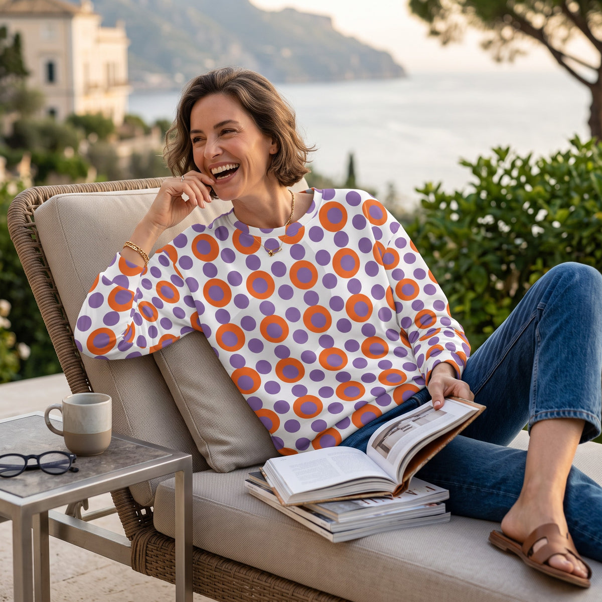 Good Wishes 365 women's recycled sweatshirt with 70s pop art orange and purple polka dots, worn by a smiling woman.