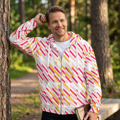 Man wearing a Good Wishes 365 recycled zip hoodie with a pink and yellow geometric line print in a forest setting.