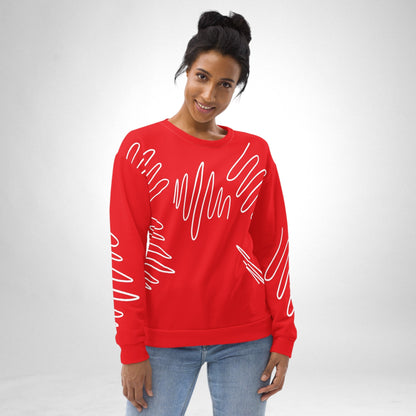 A woman wearing a Good Wishes 365 red recycled sweatshirt with a white abstract scribble pattern and crew neckline.