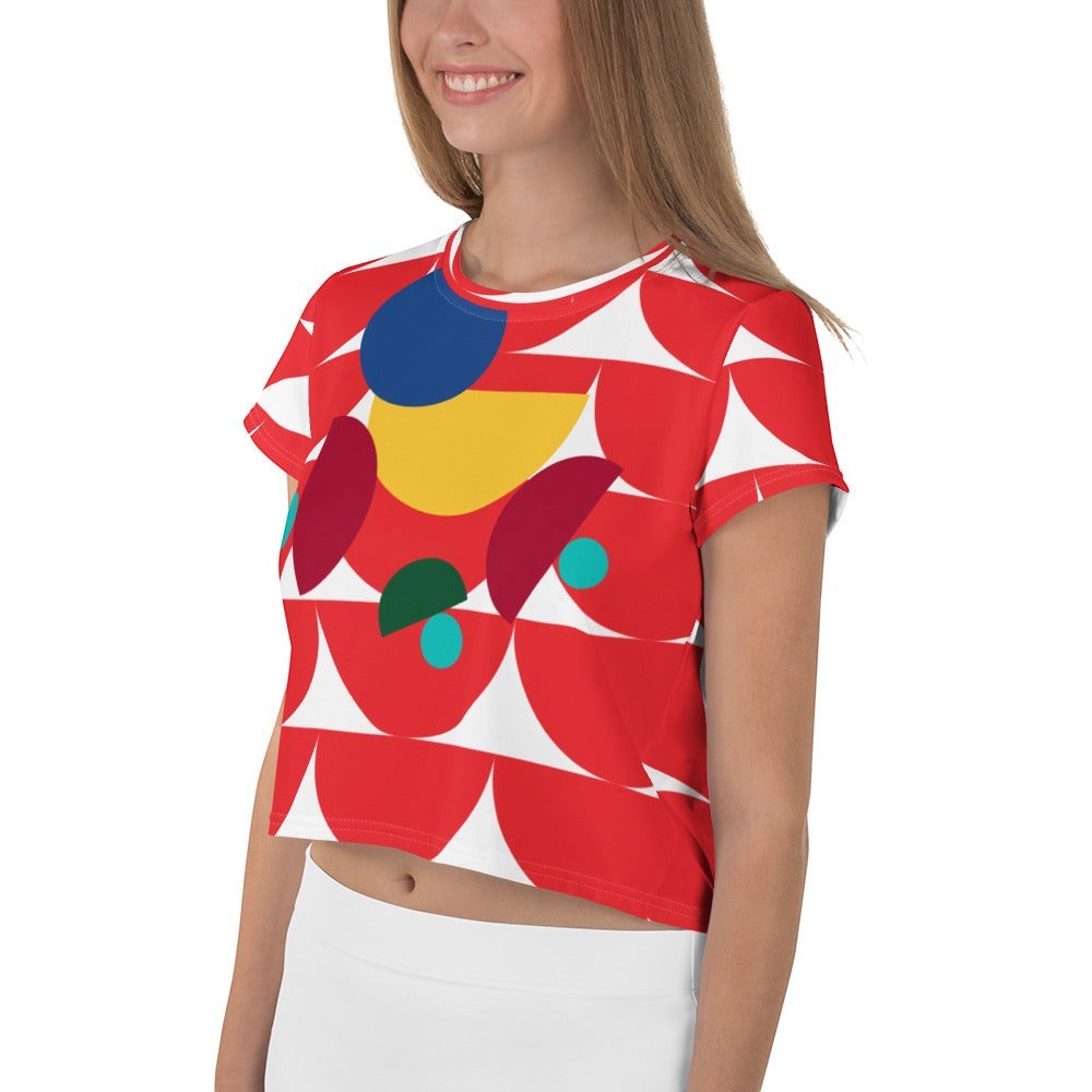 Good Wishes 365 red crop tee featuring an abstract geometric mushroom pattern in yellow, blue, and teal accents.