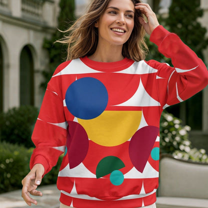 Good Wishes 365 red recycled sweatshirt with geometric mushroom graphic print worn by a smiling woman outdoors.