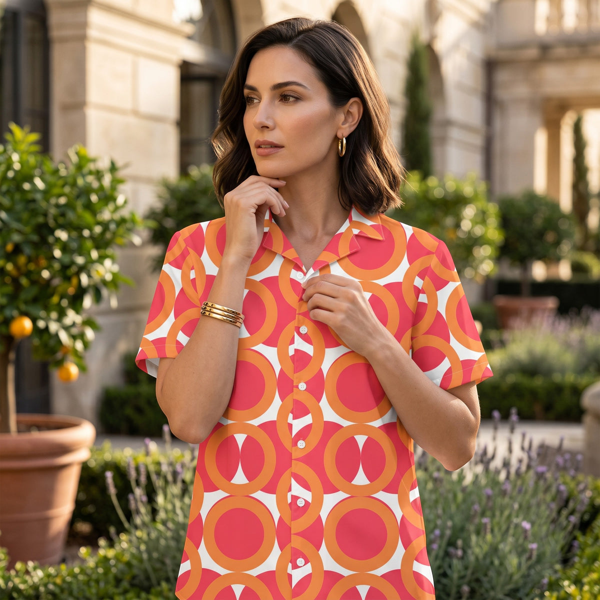 Good Wishes 365 red and orange geometric print short sleeve button shirt with UPF50+ protection worn by a woman.