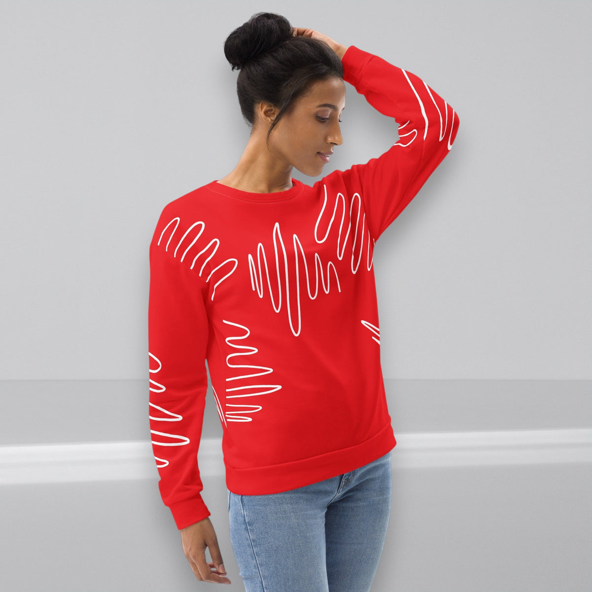 Good Wishes 365 red recycled sweatshirt with white abstract scribble lines worn by a woman with a hair bun