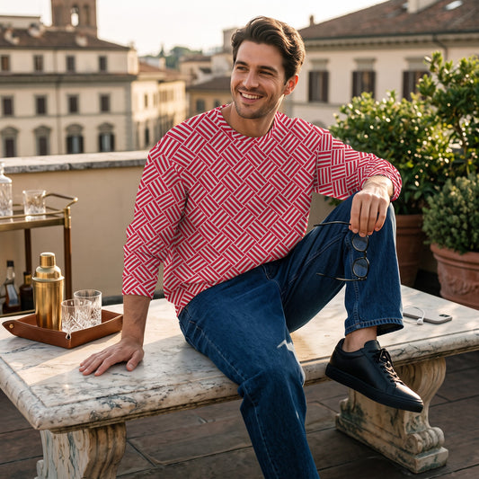 Good Wishes 365 unisex sweatshirt with a red and white geometric basketweave print, worn by a man on a rooftop terrace.