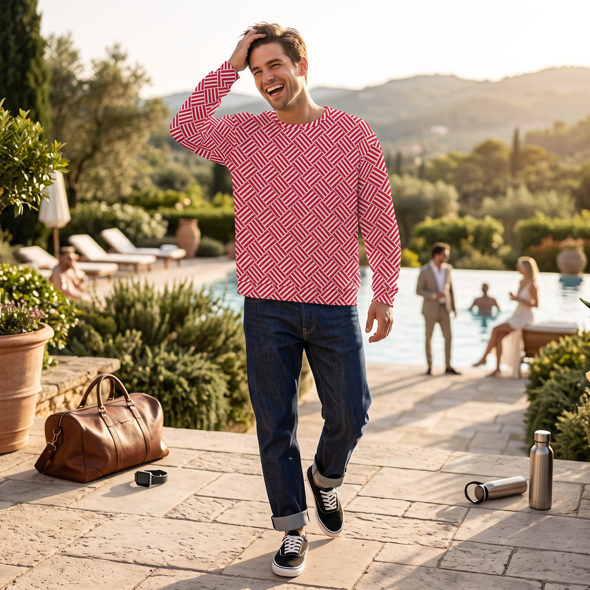 Good Wishes 365 unisex sweatshirt with red and white basketweave print, worn by a man by a sunny outdoor pool.