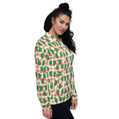 Good Wishes 365 unisex bomber jacket with pink polka dots and green semi-circles on a cream background, side view
