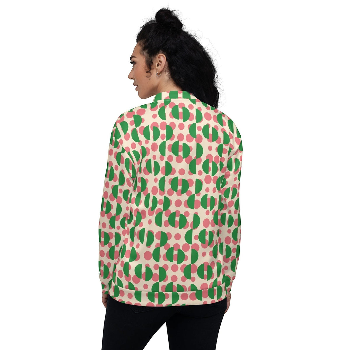 Back view of a woman wearing a Good Wishes 365 bomber jacket with a cream, pink polka dot, and green semi-circle print.