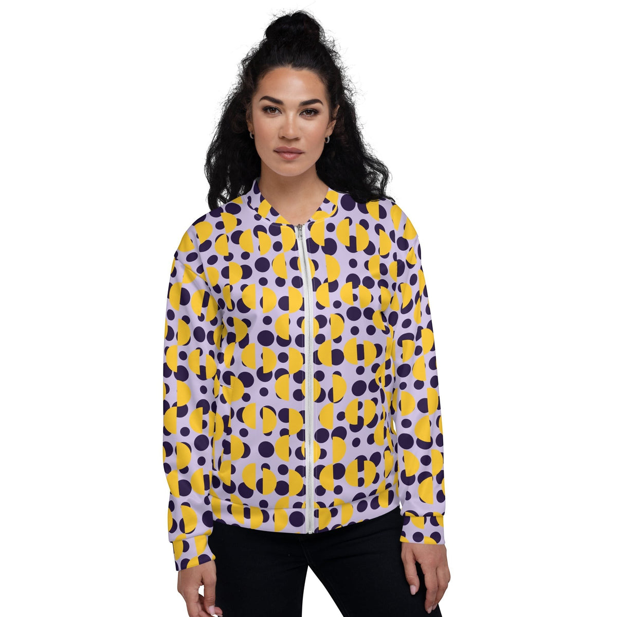 A woman wearing a Good Wishes 365 bomber jacket with a retro purple polka dot and yellow semi-circle print.
