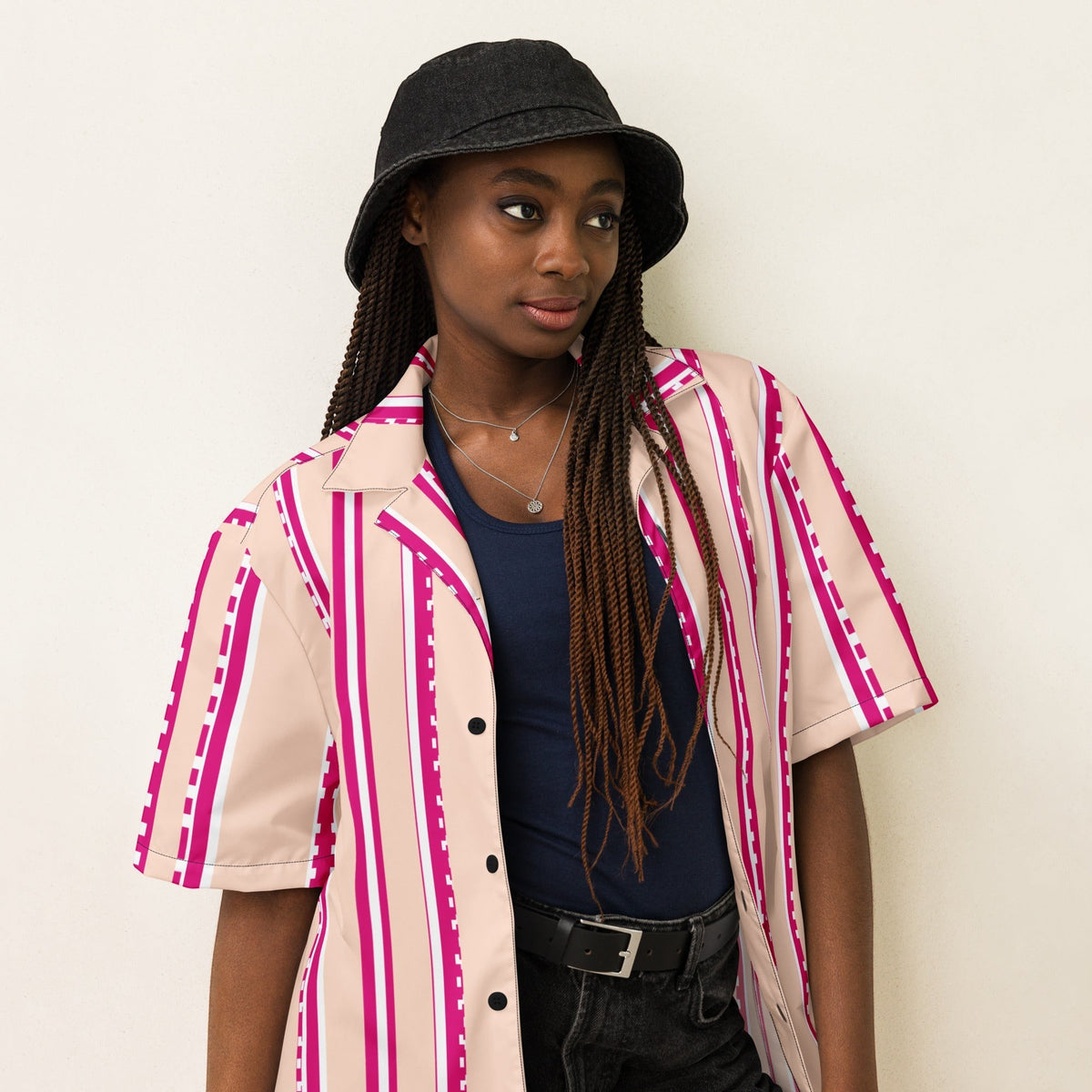 Good Wishes 365 retro pastel blush button shirt with magenta stripes worn by a model in a black bucket hat.