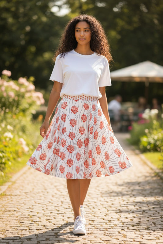 Good Wishes 365 skater skirt with an all-over print of orange-red roses and groovy gray lines on a white background. Flared, mid-thigh length.