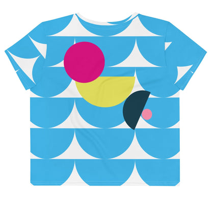 Good Wishes 365 sky blue crop tee with abstract geometric mushroom pattern in pink and yellow on a white background.