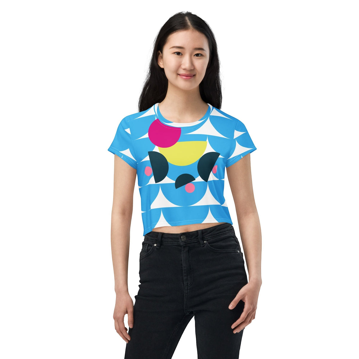 Good Wishes 365 sky blue crop tee with geometric mushroom graphic print worn by a smiling woman with black jeans
