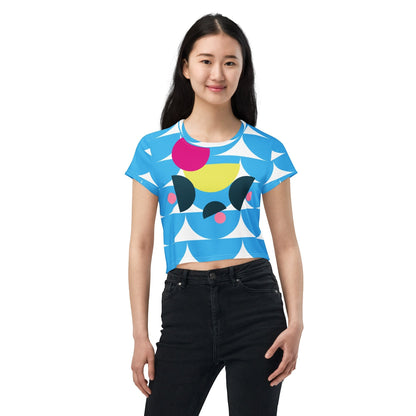 Good Wishes 365 sky blue crop tee with geometric mushroom graphic print worn by a smiling woman with black jeans