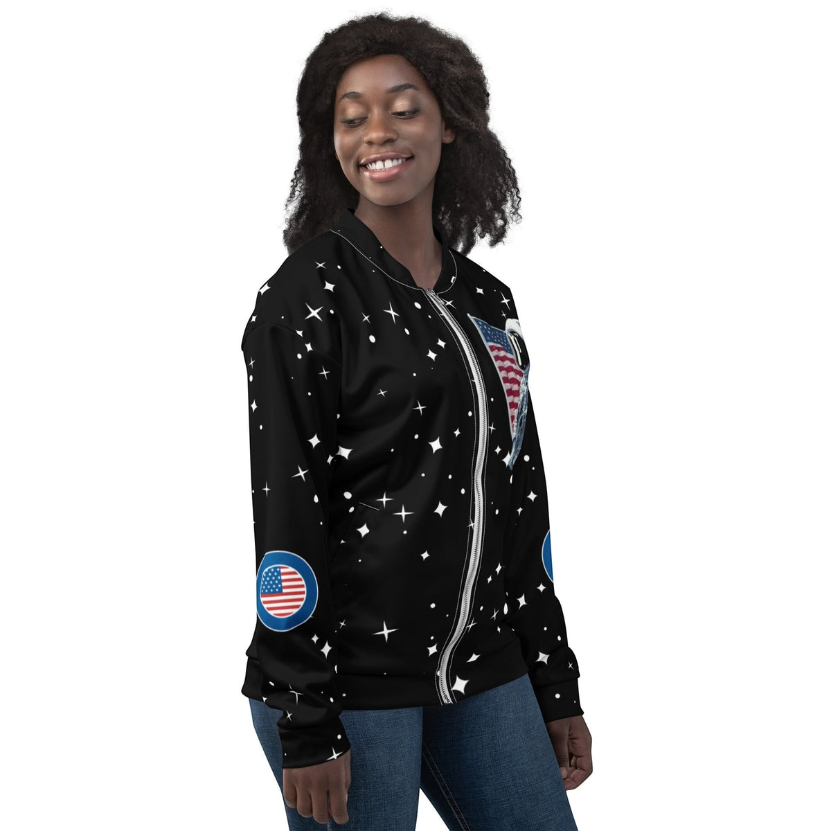 Good Wishes 365 unisex bomber jacket with black space print, stars, and American flag patches on a smiling model.