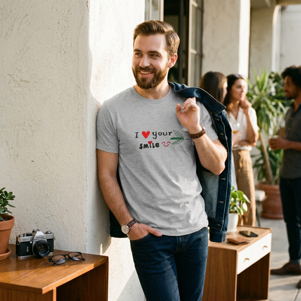 Good Wishes 365 grey unisex cotton t-shirt with I Love Your Smile graphic, worn by a smiling man outdoors.