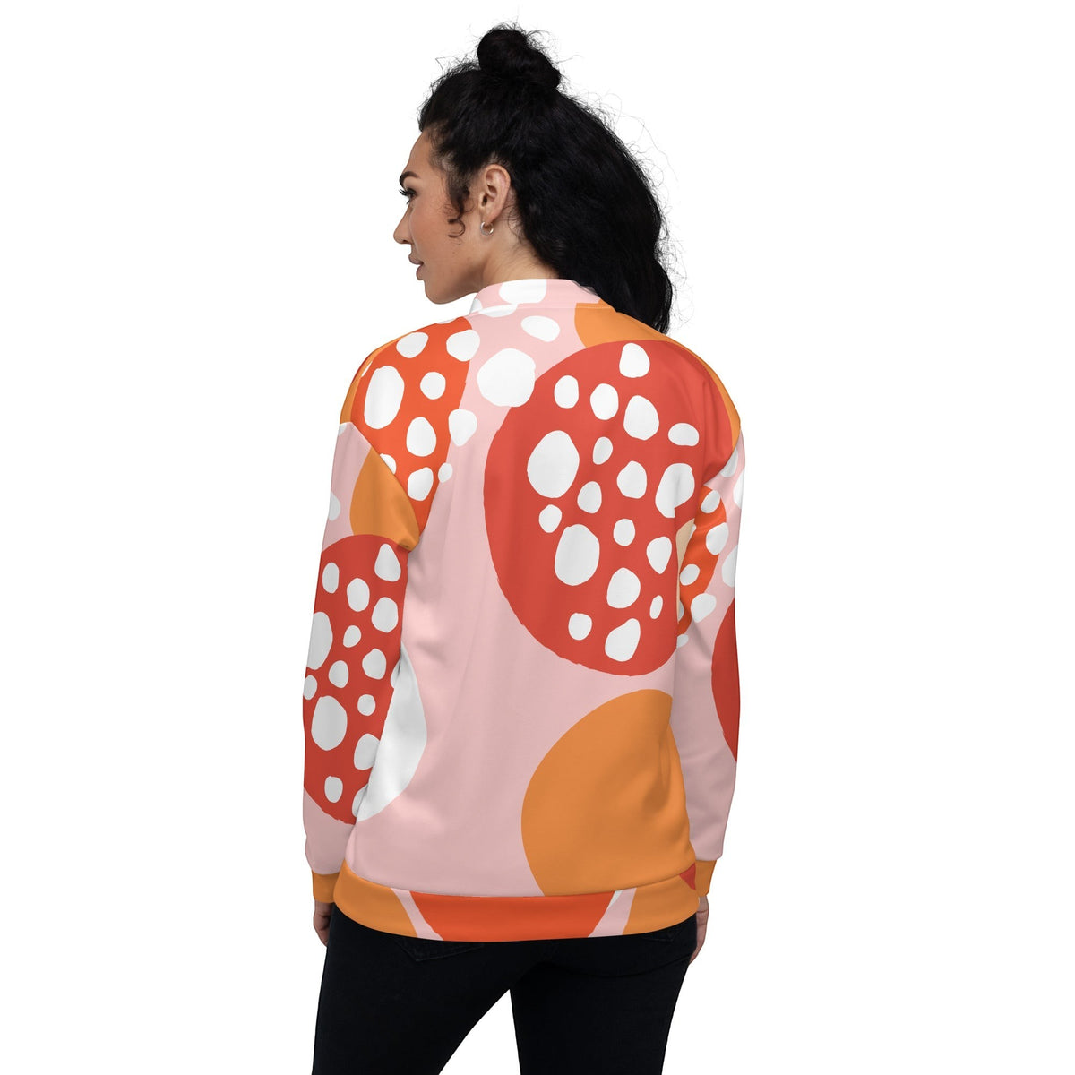 Good Wishes 365 unisex bomber jacket featuring an orange and pink strawberry-inspired all-over print on a woman.