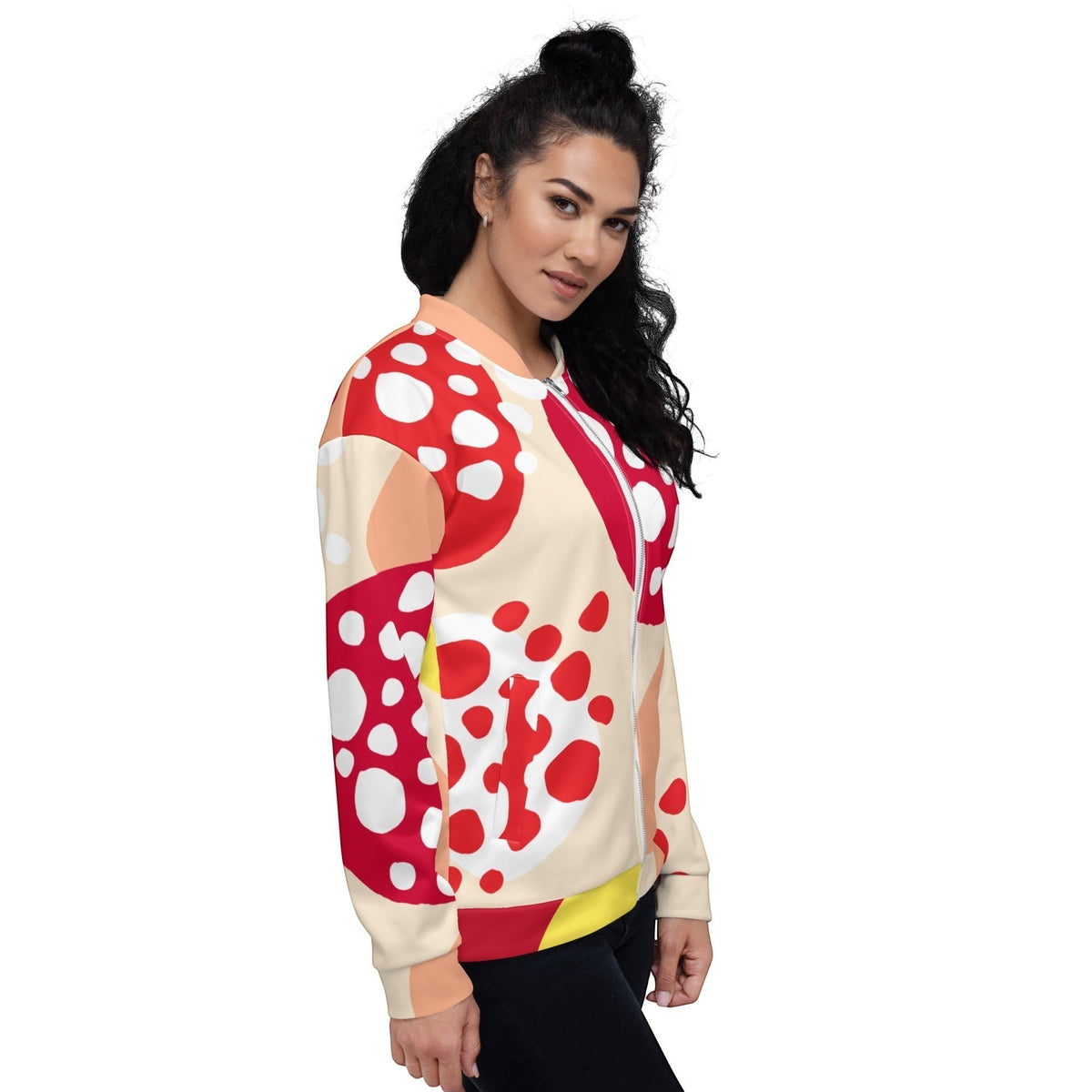 Good Wishes 365 unisex bomber jacket featuring a vibrant red, peach, and yellow abstract strawberry print on a woman.