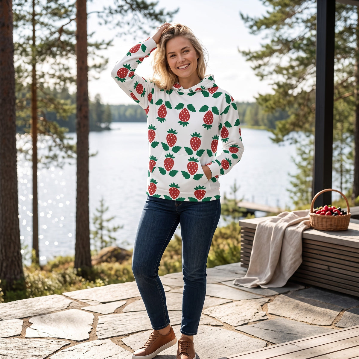 Good Wishes 365 unisex hoodie with strawberry print, white recycled fabric, kangaroo pocket, worn by a smiling woman.
