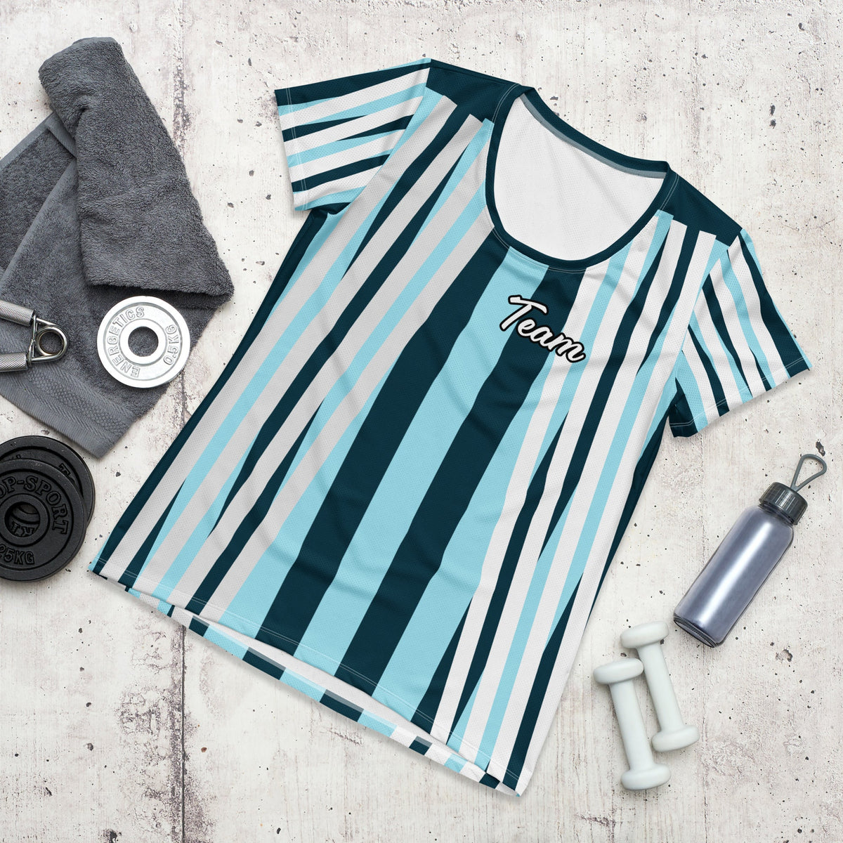 Good Wishes 365 women's athletic t-shirt with a blue, white, and navy striped pattern and Team graphic on concrete
