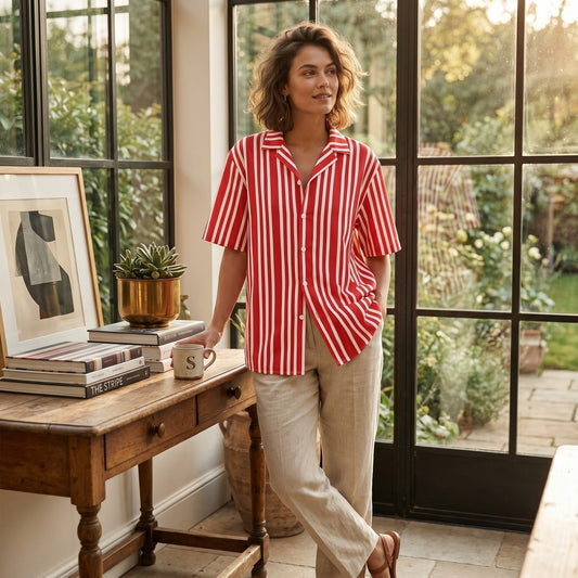 Good Wishes 365 unisex red and white striped button-down shirt with an oversized fit, worn by a woman indoors.