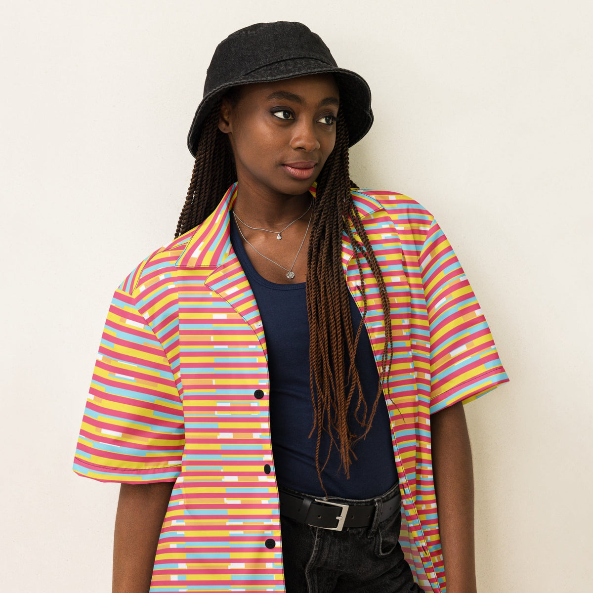 Good Wishes 365 unisex short sleeve button-up shirt with dark pink, yellow, and blue stripes worn by a model in a bucket hat