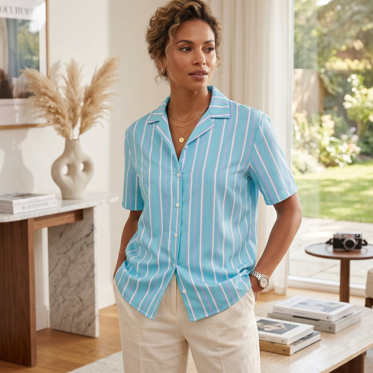 Good Wishes 365 light blue and white striped short sleeve button-up shirt with camp collar on a woman