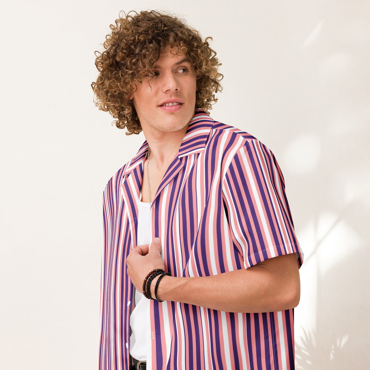 Good Wishes 365 men's purple and pink vertical striped short sleeve camp collar shirt worn over a white tank top