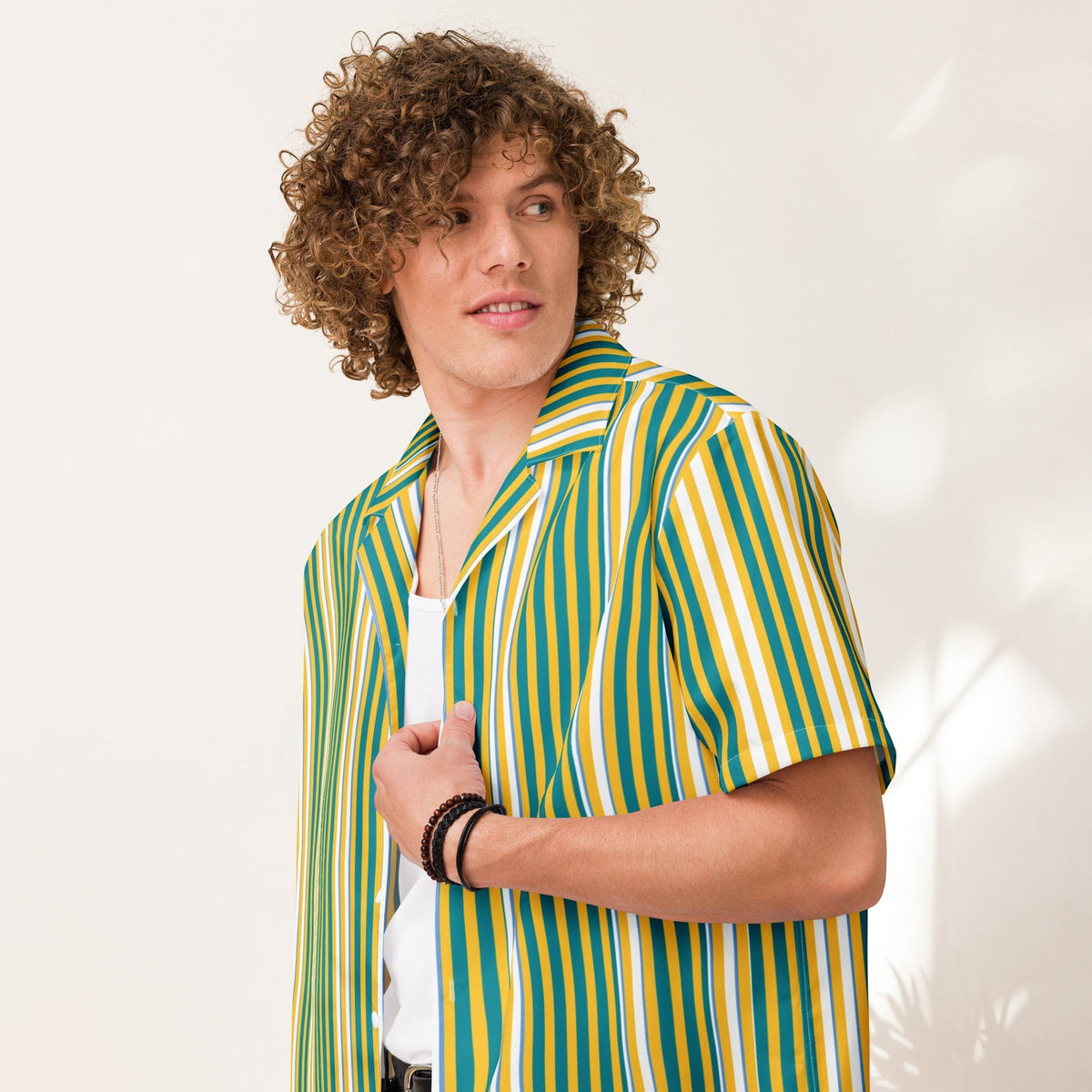 Good Wishes 365 men's yellow and blue vertical striped short sleeve camp collar shirt worn over a white tank top
