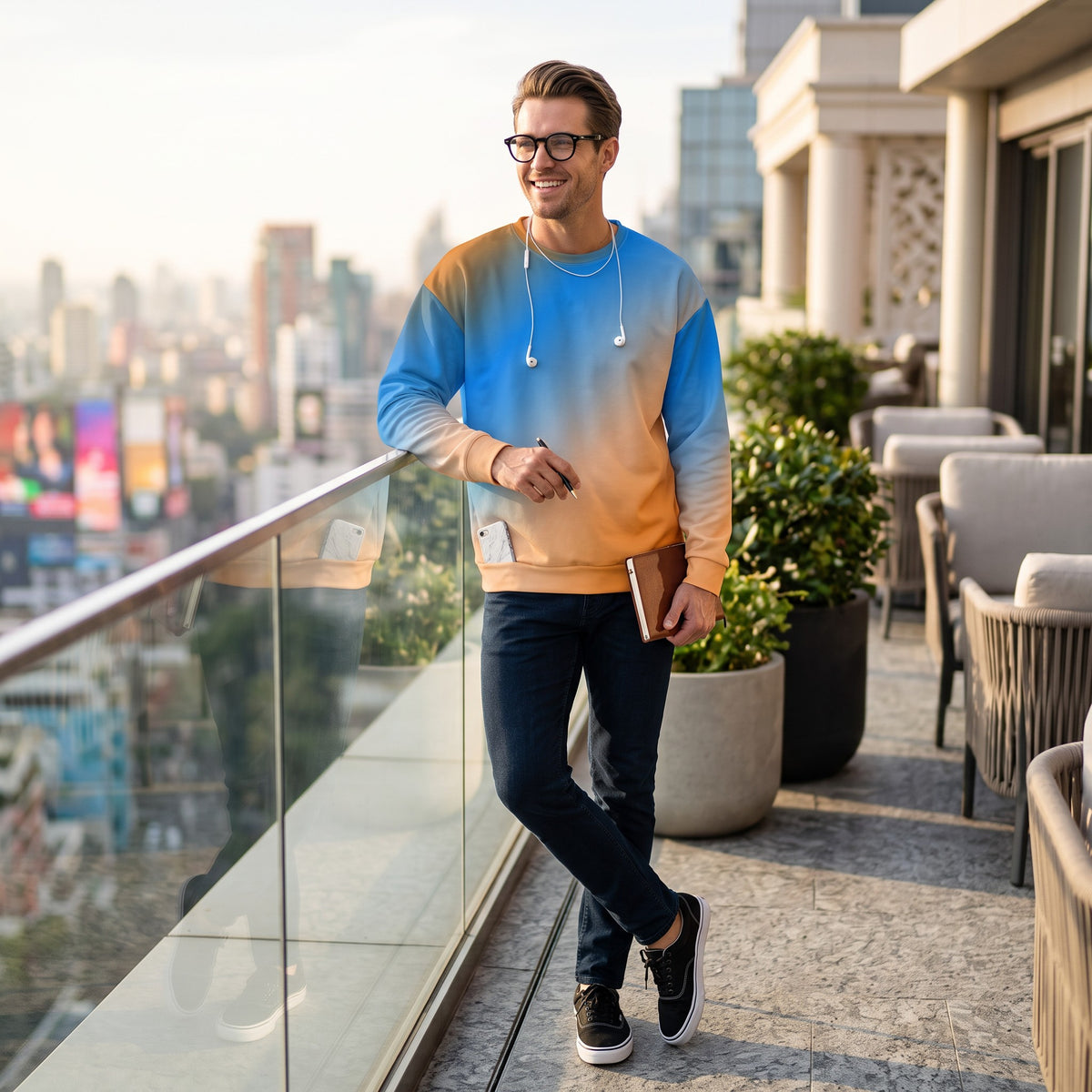 A man wearing a Good Wishes 365 recycled unisex sweatshirt with a vibrant blue and orange sunset gradient print.