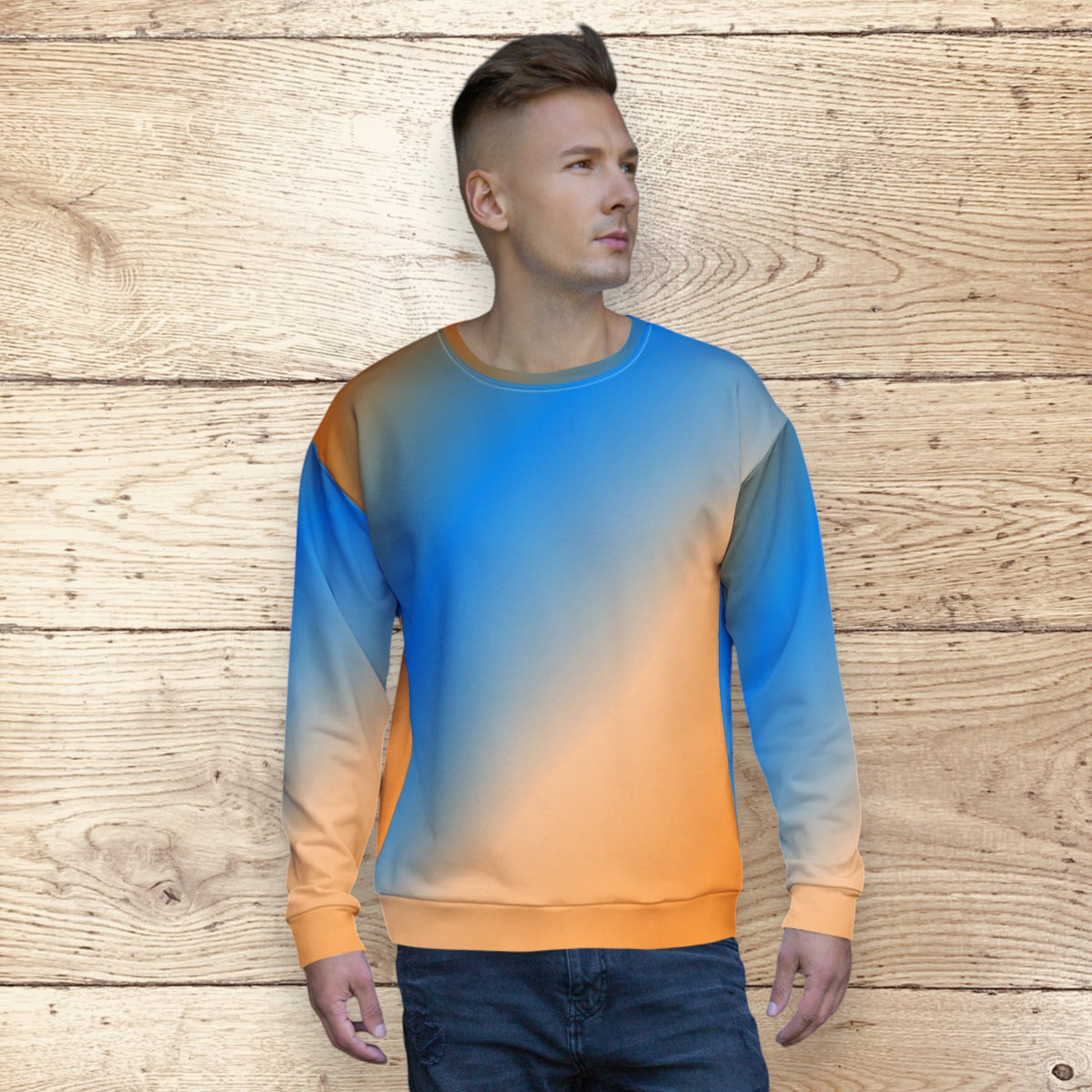 Good Wishes 365 unisex crew neck sweatshirt with a vibrant blue and orange sunset gradient print on a wooden background