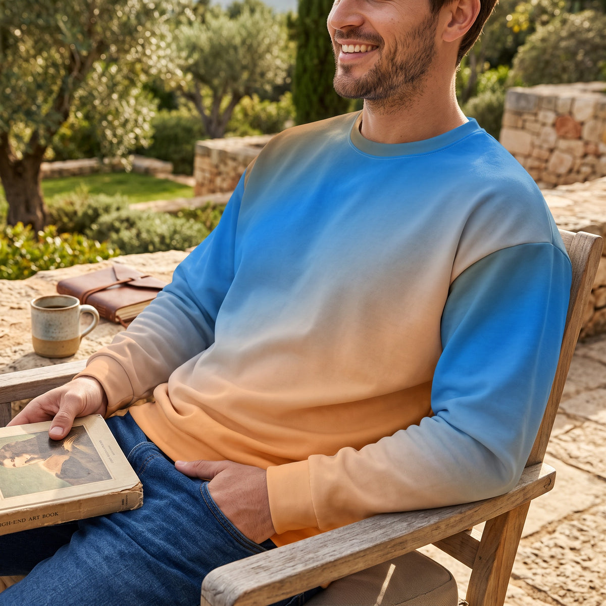 Good Wishes 365 unisex sweatshirt with a vibrant blue and orange sunset gradient print, worn by a smiling man outdoors.