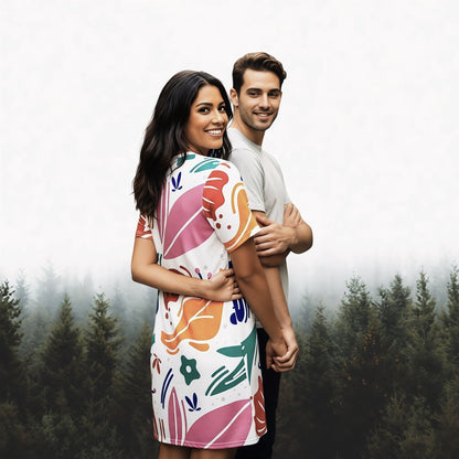 Good Wishes 365 white t-shirt dress with colorful abstract floral print, oversize fit, short sleeves, on a woman in a garden.