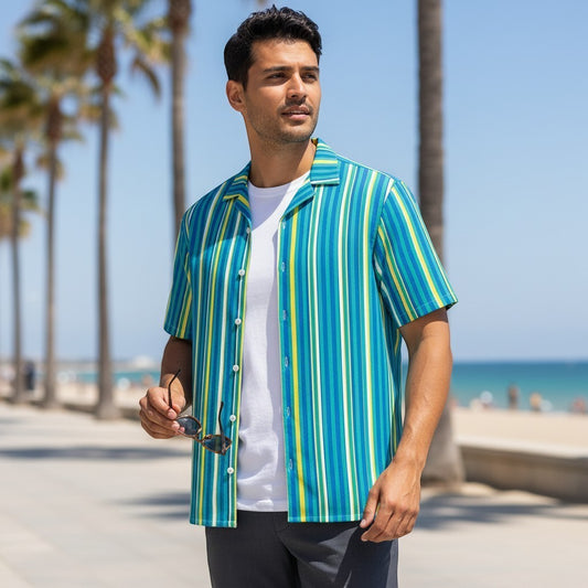 Good Wishes 365 teal striped short sleeve button-down shirt with UPF 50+ protection worn by a man on a sunny beach.