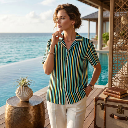 Good Wishes 365 teal striped short sleeve button-up shirt with UPF50+ protection worn by a woman by a tropical pool.