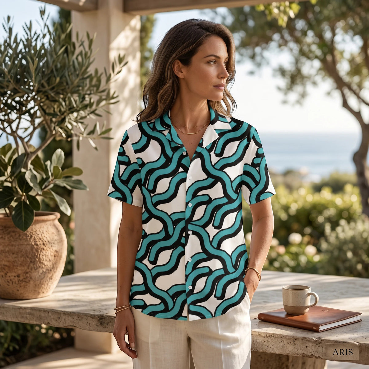 Good Wishes 365 women's teal and black abstract wave print button-down shirt with UPF50+ protection worn outdoors.