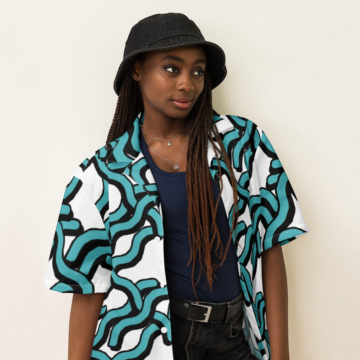 Good Wishes 365 women's teal and black abstract wave print UPF50+ button-down shirt worn by a model in a bucket hat.