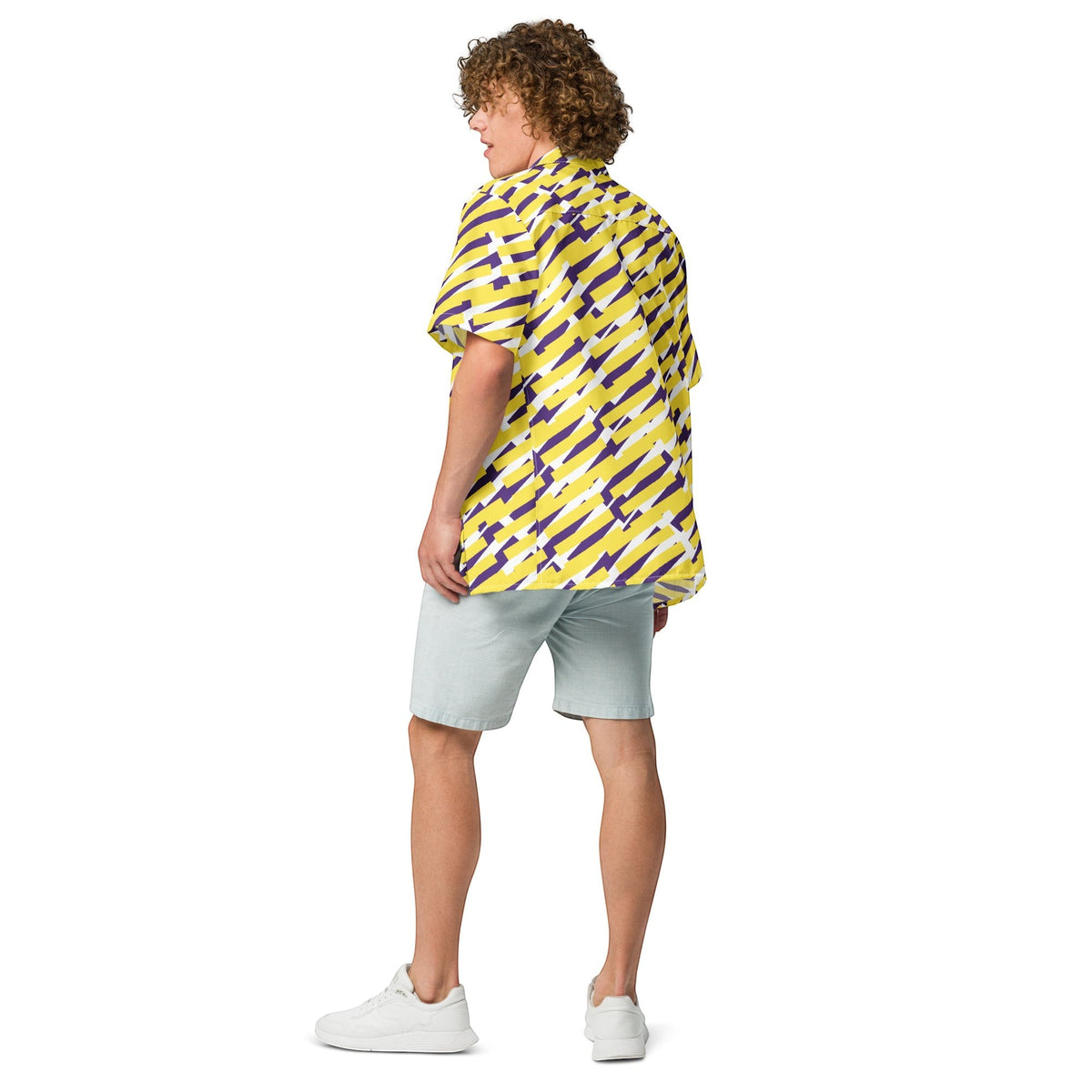 Good Wishes 365 short sleeve button down shirt with yellow and purple geometric print worn by a man from behind. All-over print, unisex button shirt, back side view. 